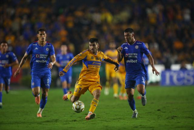 Tigres' forward # 7 Argentinean Angel Correa and Cruz Azul's midfielder #06 Erik Lira compete for the ball during the Liga MX Apertura semi-final second leg football match between Tigres and Cruz Azul at the UANL University Stadium in San Nicolas de los Garza, Nuevo Leon State, Mexico on December 6, 2025. (Photo by Julio Cesar AGUILAR / AFP)