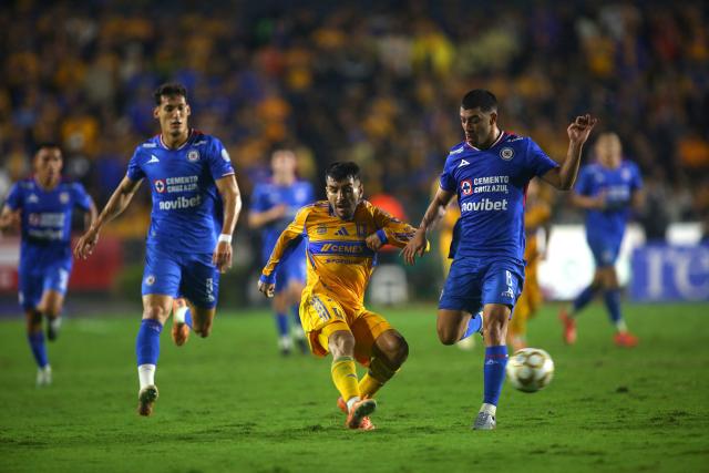 Tigres' forward # 7 Argentinean Angel Correa and Cruz Azul's midfielder #06 Erik Lira compete for the ball during the Liga MX Apertura semi-final second leg football match between Tigres and Cruz Azul at the UANL University Stadium in San Nicolas de los Garza, Nuevo Leon State, Mexico on December 6, 2025. (Photo by Julio Cesar AGUILAR / AFP)