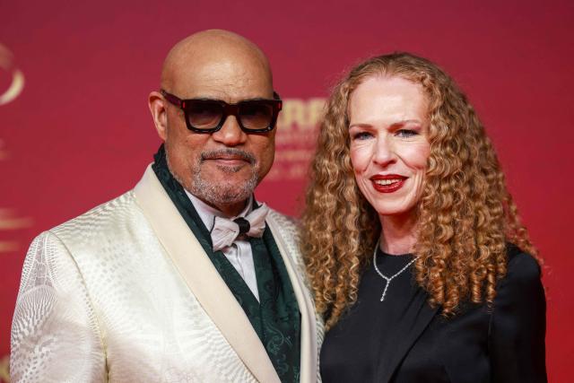 Laurence Fishburne and Bronwyn Dannenfelser pose on the red carpet as they arrive for the closing ceremony of the 22nd Marrakesh Film Festival (FIFM) in Marrakesh on December 6, 2025. (Photo by Abdel Majid BZIOUAT / AFP)