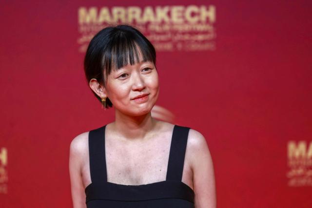 Celine Song poses on the red carpet as she arrives for the closing ceremony of the 22nd Marrakesh Film Festival (FIFM) in Marrakesh on December 6, 2025. (Photo by Abdel Majid BZIOUAT / AFP)
