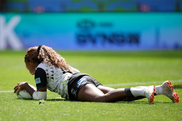 Fiji's Adita Milinia scores a try during the 5th place Semi Final HSBC World Rugby Sevens Series women's rugby match between Fiji and Canada at the DHL stadium in Cape Town on December 7, 2025. (Photo by GIANLUIGI GUERCIA / AFP)