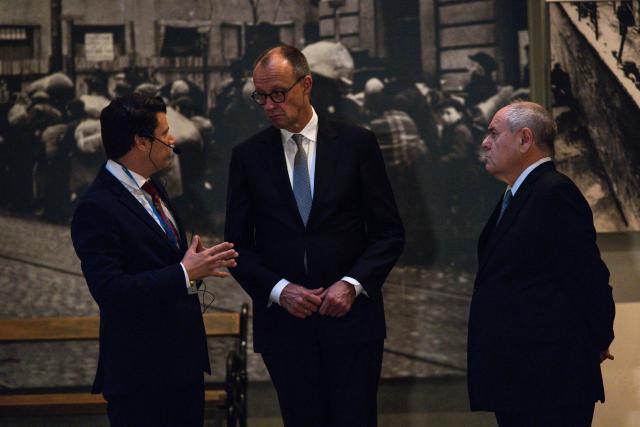 German Chancellor Friedrich Metz (C) visits the Yad Vashem Holocaust Memorial Museum in Jerusalem, on December 7, 2025. (Photo by JOHN WESSELS / POOL / AFP)