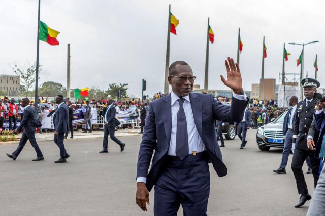 (FILES) Benin's president Patrice Talon waves upon his arrival to inspect a guard of honour during the celebrations marking the 62nd independence anniversary in Cotonou, on August 1, 2022. Military personnel in Benin on Sunday announced that they had ousted President Patrice Talon, although his entourage said he was safe and the army was regaining control.
Soldiers calling themselves the "Military Committee for Refoundation" (CMR), said on state television that they had met and decided that "Mr Patrice Talon is removed from office as president of the republic".
The announcement follows two coups in Madagascar and Guinea-Bissau in as many months. Benin is bordered in the north by Niger and Burkina Faso, which have also seen military takeovers.
The French Embassy said on X that "gunfire was reported at Camp Guezo" near the president's official residence in the economic capital. (Photo by YANICK FOLLY / AFP)