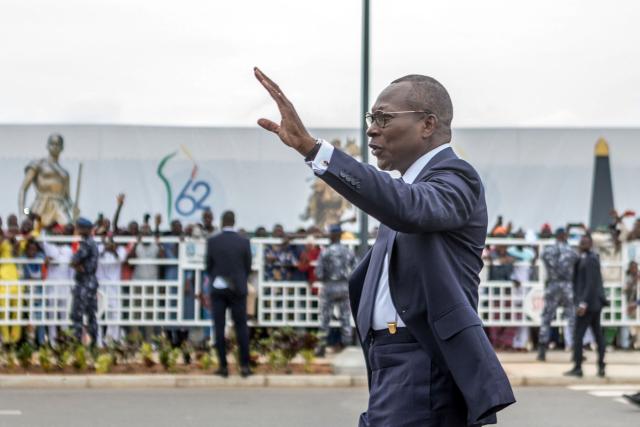 (FILES) Benin's president Patrice Talon waves on his arrival to inspect a guard of honour  during the celebrations marking the 62nd independence anniversary in Cotonou, on August 1, 2022. Military personnel in Benin on Sunday announced that they had ousted President Patrice Talon, although his entourage said he was safe and the army was regaining control.
Soldiers calling themselves the "Military Committee for Refoundation" (CMR), said on state television that they had met and decided that "Mr Patrice Talon is removed from office as president of the republic".
The announcement follows two coups in Madagascar and Guinea-Bissau in as many months. Benin is bordered in the north by Niger and Burkina Faso, which have also seen military takeovers.
The French Embassy said on X that "gunfire was reported at Camp Guezo" near the president's official residence in the economic capital. (Photo by YANICK FOLLY / AFP)