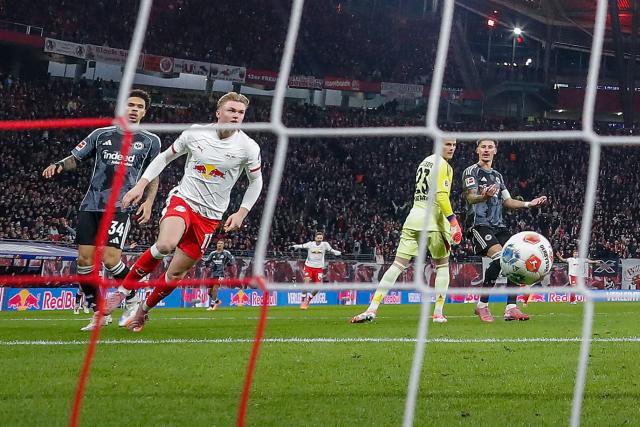 Leipzig's Danish forward #11 Conrad Harder (2ndL) scores the 1-0 opening goal during the German first division Bundesliga football match between RB Leipzig and Eintracht Frankfurt in Leipzig, eastern Germany, on December 6, 2025. (Photo by RONNY HARTMANN / AFP) / DFL REGULATIONS PROHIBIT ANY USE OF PHOTOGRAPHS AS IMAGE SEQUENCES AND/OR QUASI-VIDEO