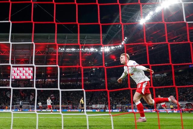 Leipzig's Danish forward #11 Conrad Harder celebrates scoring the 1-0 opening goal during the German first division Bundesliga football match between RB Leipzig and Eintracht Frankfurt in Leipzig, eastern Germany, on December 6, 2025. (Photo by RONNY HARTMANN / AFP) / DFL REGULATIONS PROHIBIT ANY USE OF PHOTOGRAPHS AS IMAGE SEQUENCES AND/OR QUASI-VIDEO