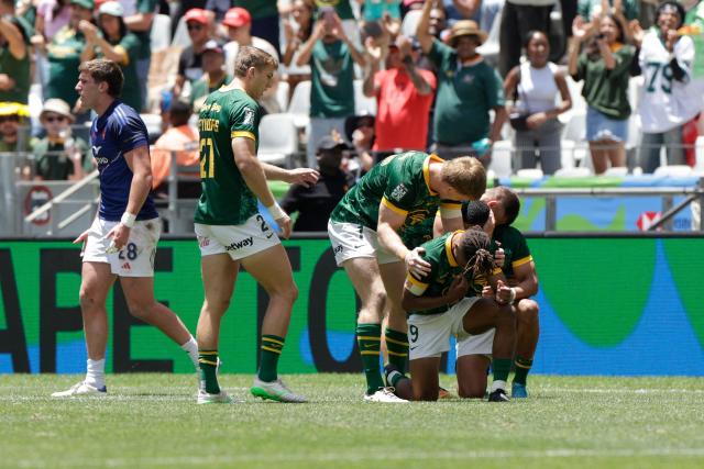 South Africa players celebrate their victory against France during the Semi Final HSBC World Rugby Sevens Series men's rugby match between South Africa and France at the DHL stadium in Cape Town on December 7, 2025. (Photo by GIANLUIGI GUERCIA / AFP)