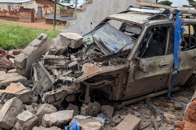 A general view of a car destroyed by shelling during intense fighting in Kamnyola on December 7, 2025. At least 20 Burundian soldiers have been killed in ongoing fighting in eastern DR Congo, military sources told AFP on Saturday, only days after a peace deal was signed in Washington.
Thursday's agreement was meant to stabilise the resource-rich east but it has had little visible effect on the ground so far, in an area plagued by conflict for 30 years.
Fighters from the anti-government armed group M23 are battling in South Kivu province with the Congolese army, backed by thousands of Burundian soldiers deployed alongside it.
Both sides are fighting for control of the border town of Kamanyola -- where the Democratic Republic of Congo, Rwanda and Burundi meet. M23 is currently in control there. (Photo by AFP)