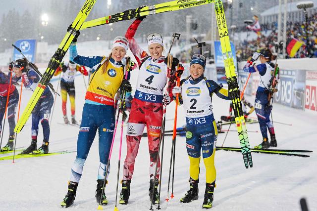 (LtoR) Second placed Finland's Suvi Minkkinen, winner Austria's Lisa Theresa Hauser,  and third placed Sweden's Anna Magnusson celebrate after the women's 10 km pursuit event of the IBU Biathlon World Cup in Oestersund, Sweden on December 7, 2025. (Photo by Bjorn LARSSON ROSVALL / TT NEWS AGENCY / AFP) / Sweden OUT