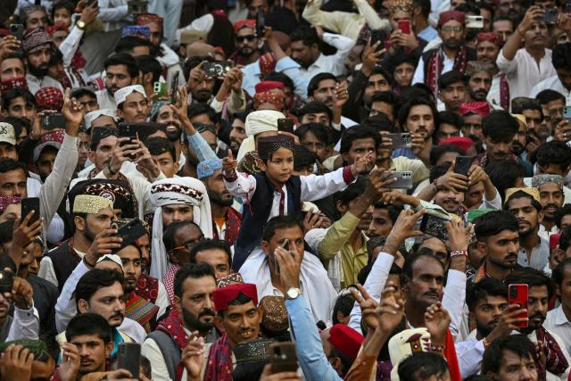 People wearing ethnic attire celebrate Sindhi Cultural Day festival in Karachi on December 7, 2025. (Photo by Asif HASSAN / AFP)