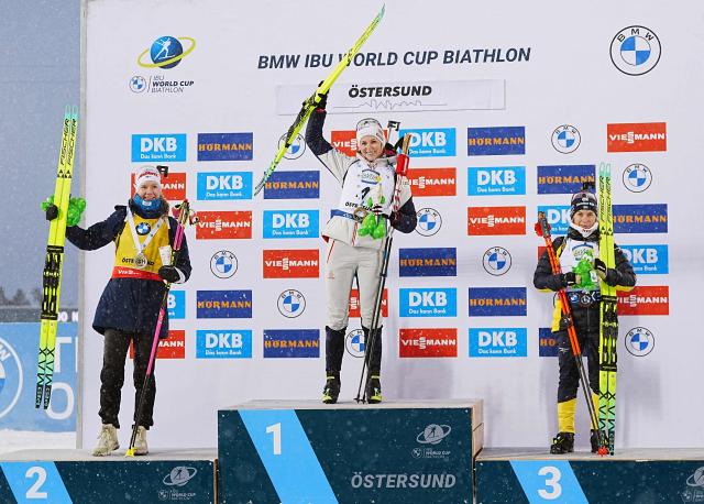 (LtoR) Second placed Finland's Suvi Minkkinen, winner Austria's Lisa Theresa Hauser,  and third placed Sweden's Anna Magnusson celebrate on the podium after the women's 10 km pursuit event of the IBU Biathlon World Cup in Oestersund, Sweden on December 7, 2025. (Photo by Bjorn LARSSON ROSVALL / TT NEWS AGENCY / AFP) / Sweden OUT