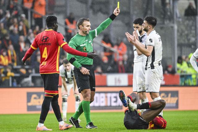 Royal Charleroi SC's Polish forward #09 Filip Szymczak (R) receives a yellow card from referee Nicolas Laforge during the Belgian "Pro League" First Division football match between KV Mechelen and Royal Charleroi SC at the AFAS Stadion in Mechelen, on December 7, 2025. (Photo by Tom Goyvaerts / Belga / AFP) / Belgium OUT