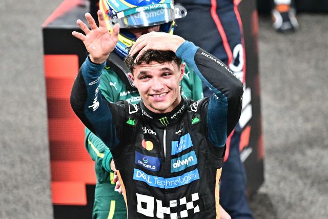 McLaren’s British driver Lando Norris celebrates after finishing the race third to win the world championship title at the end of the Abu Dhabi Formula One Grand Prix at the Yas Marina Circuit in Abu Dhabi on December 7, 2025. (Photo by Giuseppe CACACE / AFP)