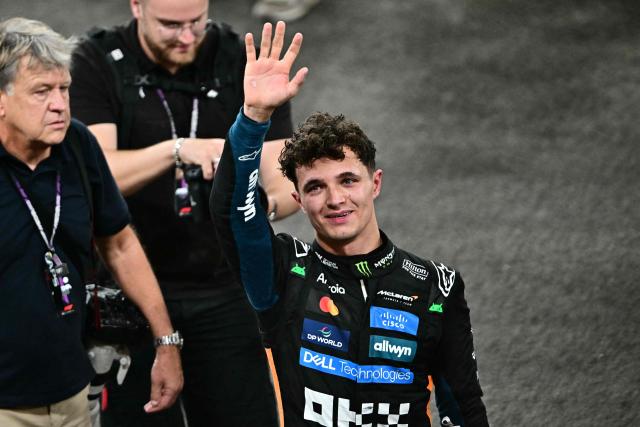 McLaren’s British driver Lando Norris celebrates after finishing the race third to win the world championship title at the end of the Abu Dhabi Formula One Grand Prix at the Yas Marina Circuit in Abu Dhabi on December 7, 2025. (Photo by Giuseppe CACACE / POOL / AFP)