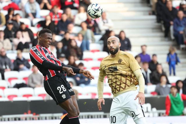 Nice's Sierra Leonean defender #28 Juma Bah (L) fights for the ball with Angers' Algerian midfielder #10 Himad Abdelli (R) during the French L1 football match between OGC Nice and SCO Angers at the Allianz Riviera stadium in Nice, south-eastern France, on December 7, 2025.  (Photo by Valery HACHE / AFP)