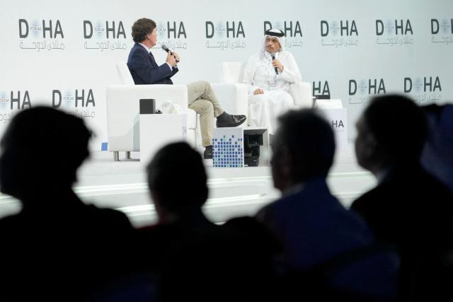 Picture of Tucker Carlson, on the left, interviewing Qatar’s PM Mohammed bin Abdulrahman bin Jassim Al Thani, on the right, at the Doha Forum in Qatar on December 07, 2025. (Photo by HASSAN BAYDOUN / MOFA / FACTSTORY) / Disclaimer: This document is neither produced nor endorsed by AFP. It is distributed under its issuer sole responsibility. Its reproduction is authorized in context without any distortion of content. If you have any question about this document, please contact its issuer.