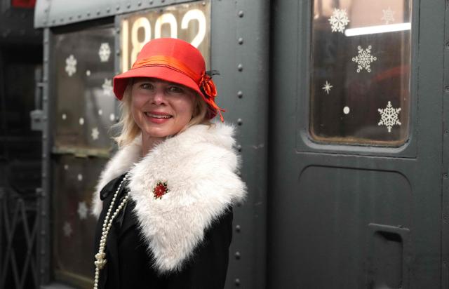 People attend the annual Holiday Nostalgia Rides in the New York City subway system in New York, on December 7, 2025. Every Holiday season, the New York Transit Museum and the NYC Transit Authority offer rides in restored vintage subway cars for a chance to step back in time. The Holiday Nostalgia Rides feature eight cars from the 1930s that served on lettered lines through the late 1970s. (Photo by TIMOTHY A. CLARY / AFP)