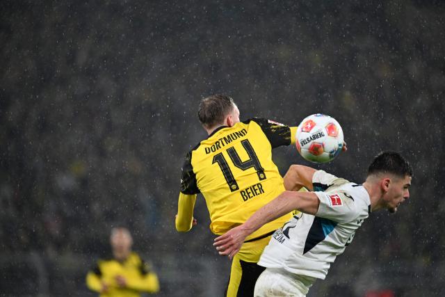 Dortmund's German forward #14 Maximilian Beier (L) and Hoffenheim's Kosovar-Swiss defender #21 Albian Hajdari  vie for the ball during the German first division Bundesliga football match between BVB Borussia Dortmund and TSG 1899 Hoffenheim in Dortmund, western Germany, on December 7, 2025. (Photo by UWE KRAFT / AFP) / DFL REGULATIONS PROHIBIT ANY USE OF PHOTOGRAPHS AS IMAGE SEQUENCES AND/OR QUASI-VIDEO