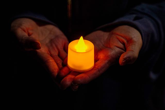 People pay their respects for the victims of a deadly fire at the Wang Fuk Court residential estate in Tai Po district of Hong Kong on December 7, 2025. (Photo by Leung Man Hei / AFP)