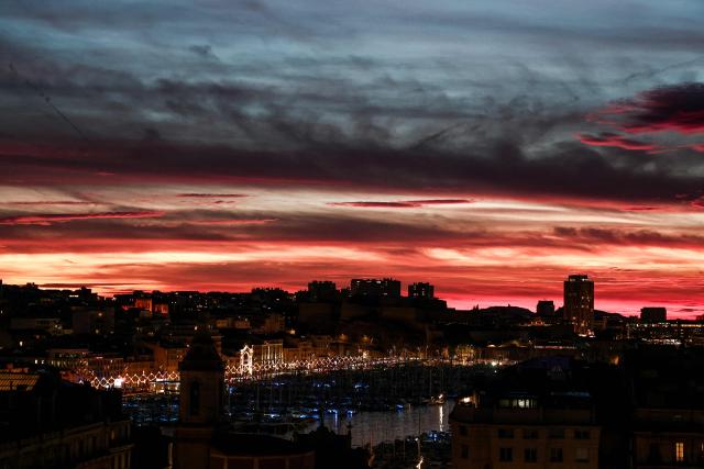This photograph taken on December 7, 2025 shows the old port of Marseille at sunset in Marseille, southern France. (Photo by Thibaud MORITZ / AFP)