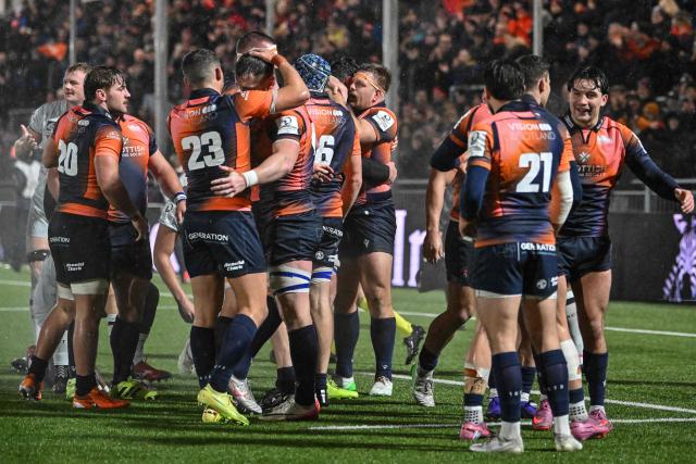 Edinburgh players celebrate at the end of the European Rugby Champions Cup pool 2 rugby union match between Edinburgh and Toulon at the Hive Stadium in Edinburgh on December 7, 2025 (Photo by ANDY BUCHANAN / AFP)