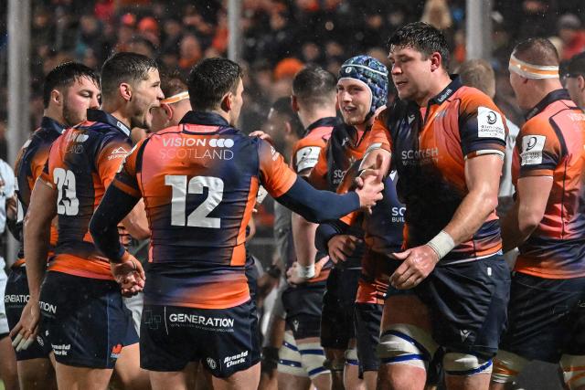 Edinburgh players celebrate at the end of the European Rugby Champions Cup pool 2 rugby union match between Edinburgh and Toulon at the Hive Stadium in Edinburgh on December 7, 2025 (Photo by ANDY BUCHANAN / AFP)