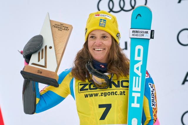 Second-place winner Sweden's Sara Hector celebrates during the victory ceremony for the Women's Giant Slalom event of the FIS Alpine Skiing World Cup in Mont-Tremblant, Quebec, Canada, on December 7, 2025. (Photo by Geoff Robins / AFP)