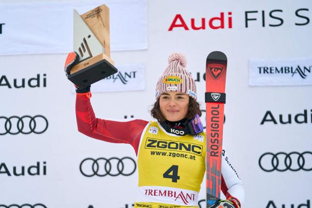 First-place winner, Austria's Julia Scheib celebrates during the victory ceremony for the Women's Giant Slalom event of the FIS Alpine Skiing World Cup in Mont-Tremblant, Quebec, Canada, on December 7, 2025. (Photo by Geoff Robins / AFP)
