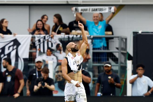Santos' midfielder #16 Thaciano celebrates after scoring during the Brasileirao Serie A football match between Santos and Cruzeiro at the Urbano Caldeira Stadium in Santos, Sao Paulo state, Brazil on December 7, 2025. (Photo by Miguel Schincariol / AFP)