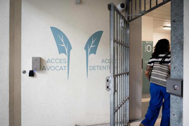 A person walks in the newly inaugurated detention center of Basse-Terre in the French archipelago of Guadeloupe, on December 7, 2025. The French Minister of Justice inaugurated on December 7, 2025 in Basse-Terre, the prefecture of the Guadeloupe archipelago, the new detention center that had been under construction for several years. (Photo by Carla Bernhardt / AFP)