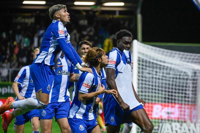 FC Porto's Spanish forward #09 Samuel Omorodion (R) celebrates scoring his team's first goal during the Portuguese League football match between between CD Tondela and FC Porto at at the Joao Cardoso stadium in Tondela on December 7, 2025. (Photo by Miguel RIOPA / AFP)