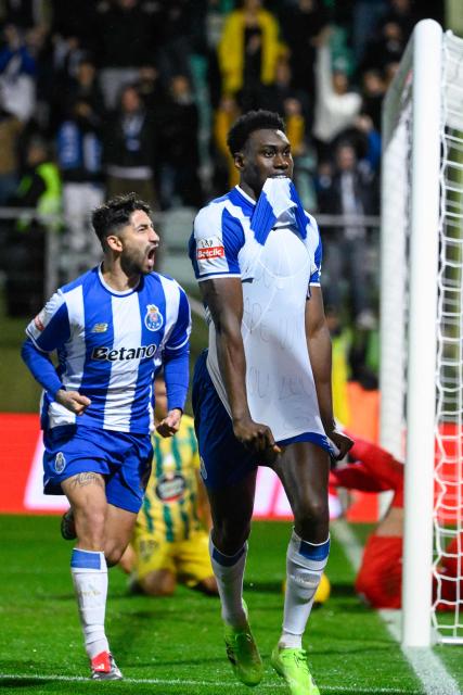 FC Porto's Spanish forward #09 Samuel Omorodion (R) celebrates scoring his team's first goal during the Portuguese League football match between between CD Tondela and FC Porto at at the Joao Cardoso stadium in Tondela on December 7, 2025. (Photo by Miguel RIOPA / AFP)