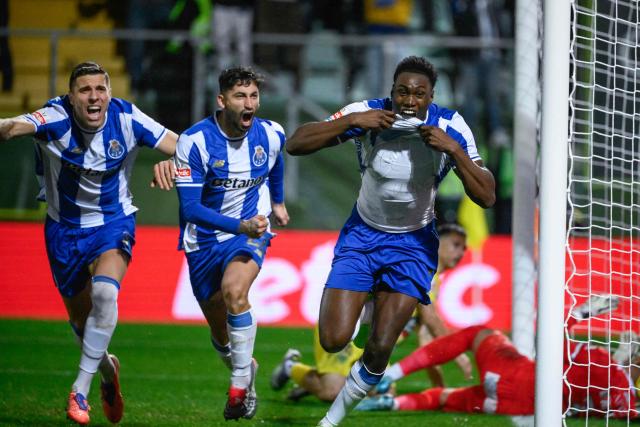 FC Porto's Spanish forward #09 Samuel Omorodion (R) celebrates scoring his team's first goal during the Portuguese League football match between between CD Tondela and FC Porto at at the Joao Cardoso stadium in Tondela on December 7, 2025. (Photo by Miguel RIOPA / AFP)