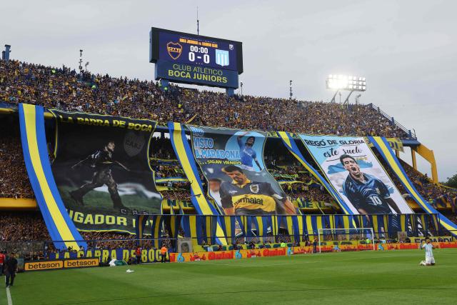 Boca Juniors fans cheer for their team ahead of the Argentine Professional Football League 2025 Clausura Tournament semifinal match between Boca Juniors and Racing at La Bombonera Stadium in Buenos Aires on December 7, 2025. (Photo by ALEJANDRO PAGNI / AFP)