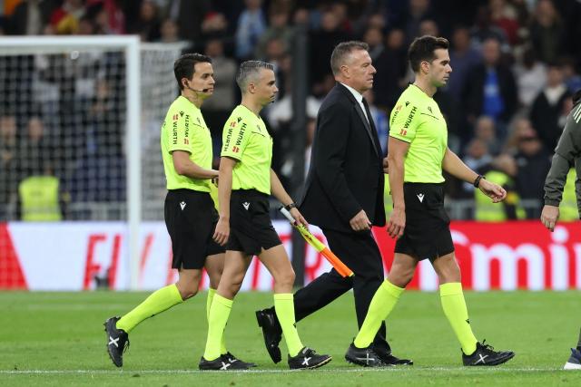 Referee Alejandro Quintero (R) and assistant referees walk off the pitch at the end of the Spanish league football match between Real Madrid CF and RC Celta de Vigo at the Santiago Bernabeu Stadium in Madrid on December 7, 2025. (Photo by Thomas COEX / AFP)