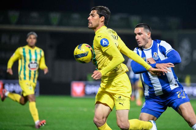 Tondela's Portuguese defender #05 Joao Afonso controls the ball ahead of FC Porto's Turkish forward #27 Deniz Gul (R) during the Portuguese League football match between between CD Tondela and FC Porto at at the Joao Cardoso stadium in Tondela on December 7, 2025. (Photo by Miguel RIOPA / AFP)