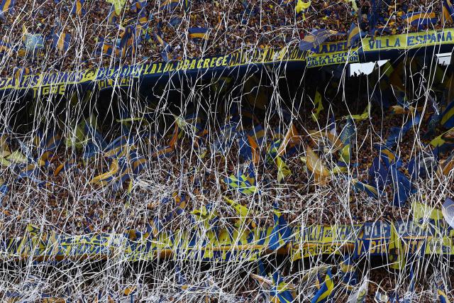 Boca Juniors fans throw paper streamers as they cheer for their team ahead of the Argentine Professional Football League 2025 Clausura Tournament semifinal match between Boca Juniors and Racing at La Bombonera Stadium in Buenos Aires on December 7, 2025. (Photo by Alejandro PAGNI / AFP)