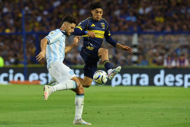 Racing's defender #03 Marco Di Cesare (L) and Boca Juniors' forward #07 Exequiel Zeballos fight for the ball during the Argentine Professional Football League 2025 Clausura Tournament semifinal match between Boca Juniors and Racing at La Bombonera Stadium in Buenos Aires on December 7, 2025. (Photo by ALEJANDRO PAGNI / AFP)
