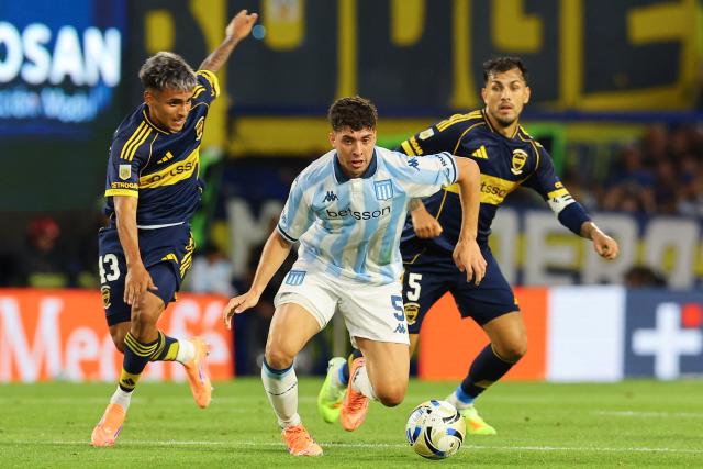 Racing's midfielder #05 Juan Ignacio Nardoni fights for the ball with Boca Juniors' midfielder #43 Milton Delgado and midfielder #05 Leandro Paredes during the Argentine Professional Football League 2025 Clausura Tournament match between Boca Juniors and River Plate at the La Bombonera Stadium in Buenos Aires on November 9, 2025. (Photo by ALEJANDRO PAGNI / AFP)