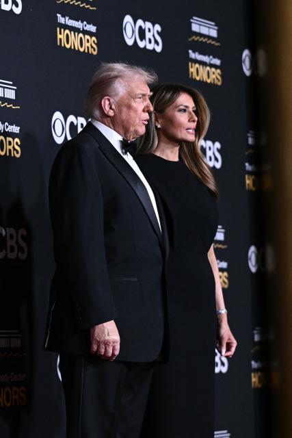 US President Donald Trump and First Lady Melania Trump arrive for the 48th Kennedy Center Honors gala at the Kennedy Center in Washington, DC, on December 7, 2025. (Photo by Brendan SMIALOWSKI / AFP)