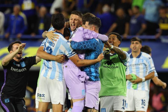 Racing players celebrate after winning the Argentine Professional Football League 2025 Clausura Tournament semifinal match between Boca Juniors and Racing at La Bombonera Stadium in Buenos Aires on December 7, 2025. (Photo by ALEJANDRO PAGNI / AFP)