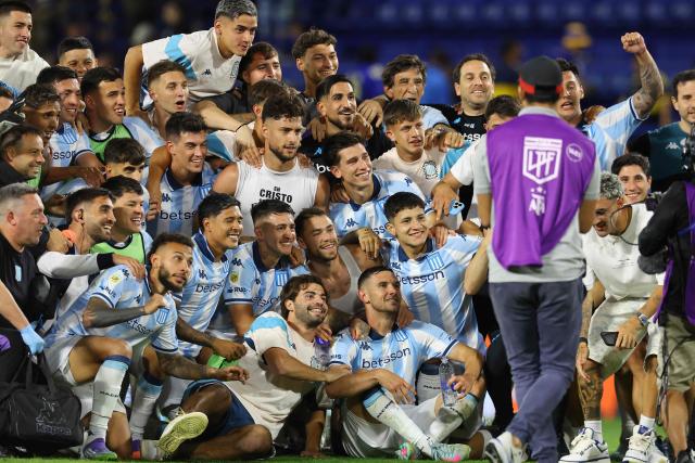 Racing players celebrate after winning the Argentine Professional Football League 2025 Clausura Tournament semifinal match between Boca Juniors and Racing at La Bombonera Stadium in Buenos Aires on December 7, 2025. (Photo by ALEJANDRO PAGNI / AFP)