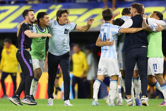 Racing's head coach Gustavo Costas (3rd L) celebrates with his players after winning the Argentine Professional Football League 2025 Clausura Tournament semifinal match between Boca Juniors and Racing at La Bombonera Stadium in Buenos Aires on December 7, 2025. (Photo by ALEJANDRO PAGNI / AFP)