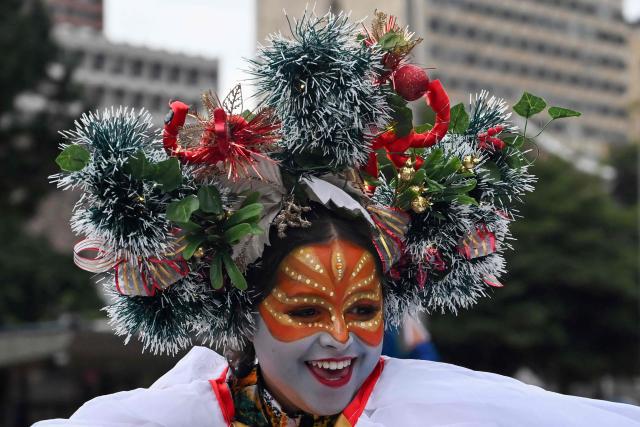 An artists take part in a Christmas parade in Bogota on December 7, 2025. (Photo by Raul ARBOLEDA / AFP)