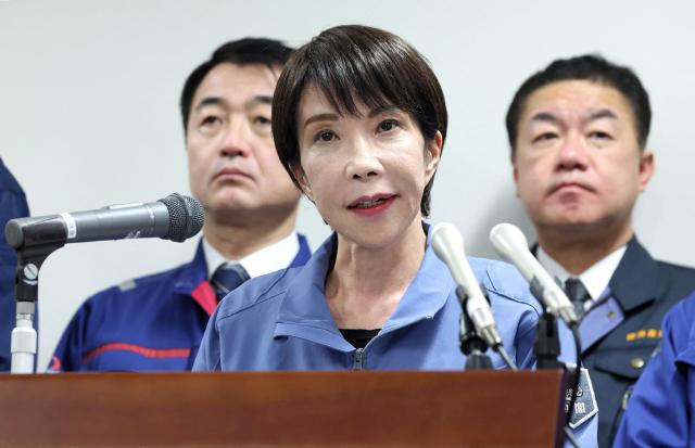 Japan's Prime Minister Sanae Takaichi responds to questions from reporters after completing her inspection tour in Wajima City, Ishikawa Prefecture on December 7, 2025. (Photo by JAPAN POOL / JIJI PRESS / AFP) / Japan OUT