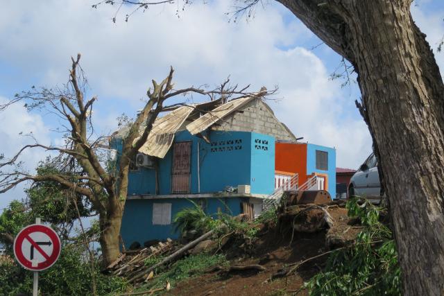 This photograph shows a damaged house following the cyclone Chido in the village of Sada, on the French Indian Ocean territory of Mayotte, on December 15, 2024. One year after Cyclone Chido devastated the Indian Ocean archipelago, ‘nothing has been done,’ laments one resident. "Thousands of affected households remain without adequate and decent housing," warns the Housing Foundation. (Photo by Marine GACHET / AFP)