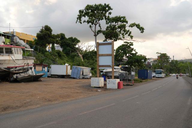 This photograph shows a street a year after the cyclone Chido in Mamoudzou, on the French Indian Ocean territory of Mayotte, on December 5, 2025. One year after Cyclone Chido devastated the Indian Ocean archipelago, ‘nothing has been done,’ laments one resident. "Thousands of affected households remain without adequate and decent housing," warns the Housing Foundation. (Photo by Marine GACHET / AFP)