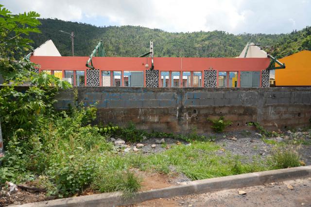 This photograph shows a school a year after the cyclone Chido in the village of Acoua, on the French Indian Ocean territory of Mayotte, on December 6, 2025. One year after Cyclone Chido devastated the Indian Ocean archipelago, ‘nothing has been done,’ laments one resident. "Thousands of affected households remain without adequate and decent housing," warns the Housing Foundation. (Photo by Marine GACHET / AFP)
