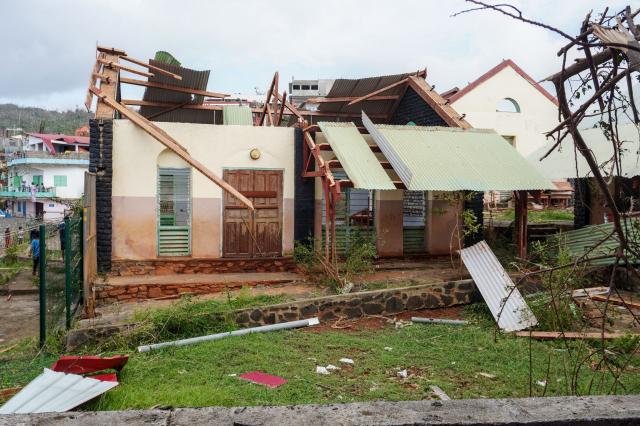 This photograph shows a damaged school following the cyclone Chido in the village of Sada, on the French Indian Ocean territory of Mayotte, on December 15, 2024. One year after Cyclone Chido devastated the Indian Ocean archipelago, ‘nothing has been done,’ laments one resident. "Thousands of affected households remain without adequate and decent housing," warns the Housing Foundation. (Photo by Marine GACHET / AFP)