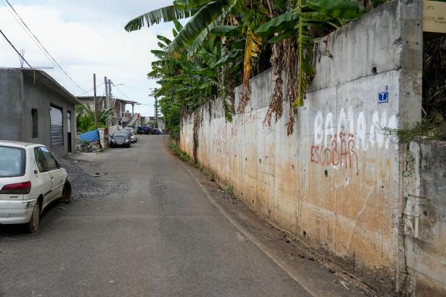 This photograph shows a street a year after the cyclone Chido in the village of Sada, on the French Indian Ocean territory of Mayotte, on December 5, 2025. One year after Cyclone Chido devastated the Indian Ocean archipelago, ‘nothing has been done,’ laments one resident. "Thousands of affected households remain without adequate and decent housing," warns the Housing Foundation. (Photo by Marine GACHET / AFP)